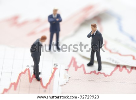 Financial crisis. Figures of businessman on financial charts