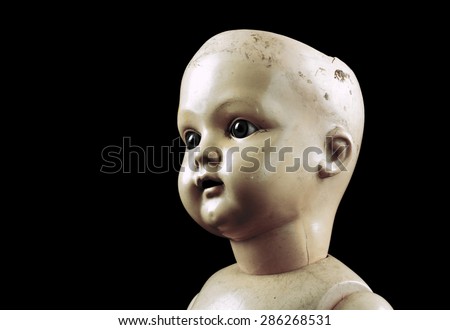 Vintage doll face isolated on black with clipping path