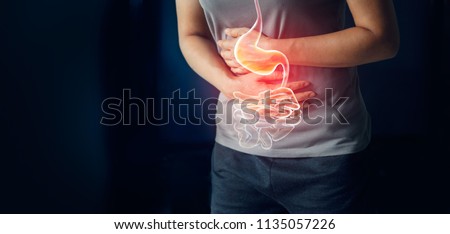 Woman touching stomach painful suffering from stomachache causes of menstruation period, gastric ulcer, appendicitis or gastrointestinal system desease. Healthcare and health insurance concept