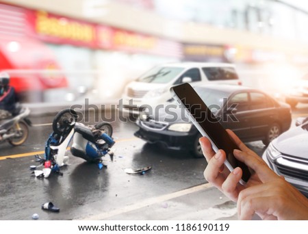 Dangerous traffic on the road, Careless driving car collides with motorcycle. Woman hands using smartphone calling ambulance and car insurance service. Concept  car accidents, emergency and insurance.
