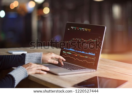 Businessman using laptop for analyzing data stock market, forex trading graph, stock exchange trading online, financial investment concept. All on laptop screen are designed up.