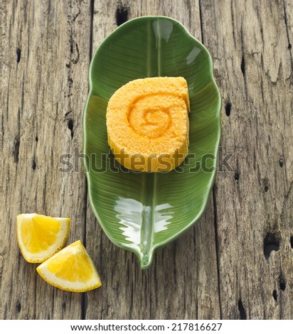 Orange roll cake on banana leaf plate