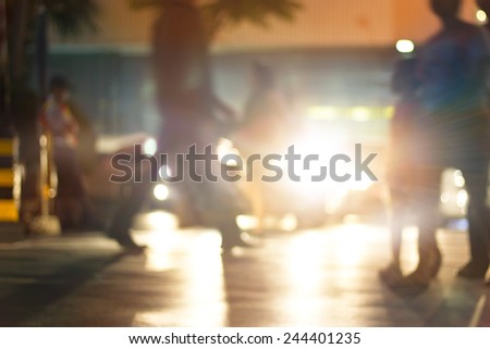 abstract people walk street at night in the city, colorful and blur concept