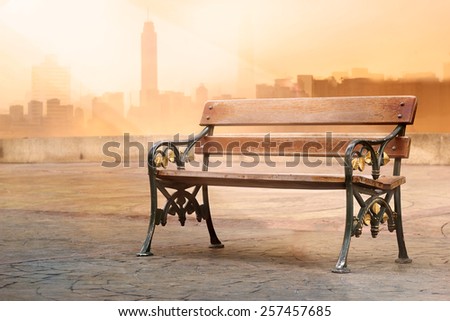 vintage color tone style of wooden bench antique with sunrise on flat top of a roof, soft focus