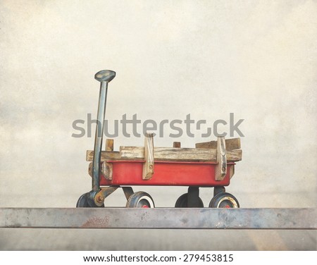 Red pull trolley toys, old rusty wagon, Vintage color tone on paper grain background