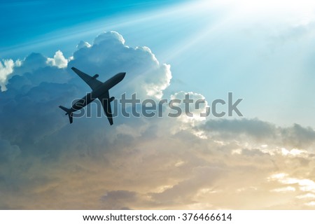 Airplane in the sky and cloud at sunrise