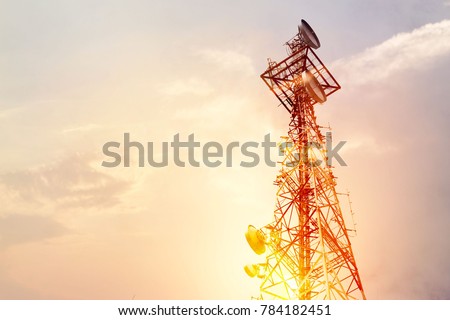 Abstract telecommunication tower Antenna and satellite dish at sunset sky background