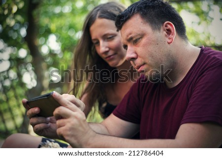 Couple watching film on smart phone