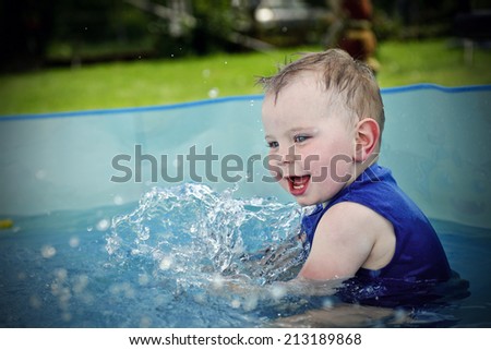 Small boy playing in swimming pool