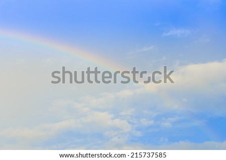 Rainbow and sun ray over the cloud and blue sky right after the rain