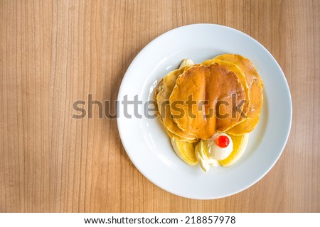 Pancake, banana, and butter for breakfast