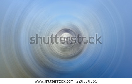 Abstract Background Of Spin Circle Radial Motion Blur in blue, white, and green with grainy texture