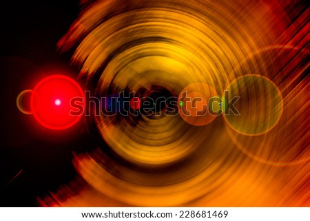Abstract background of spin circle radial motion blur in metallic red gold with flare