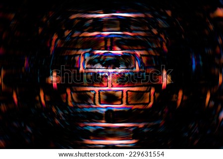 Abstract dark background of spin circle radial blur of a brick wall in black and orange