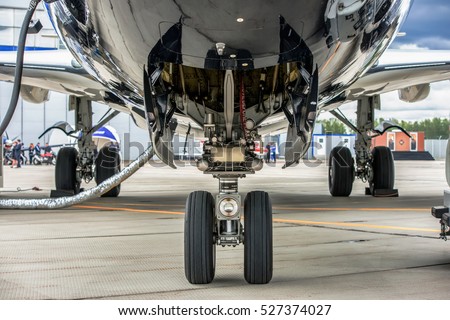 Front landing gear of big passenger aircraft closeup high detailed view.