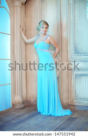 Luxury woman in fashionable dress in expensive interior
