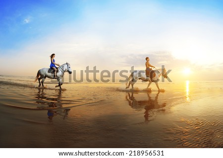 Love background. Family and horse in the sunshine. Couple in love on beach in sunset. Ride horseback of the sea in sun rays.