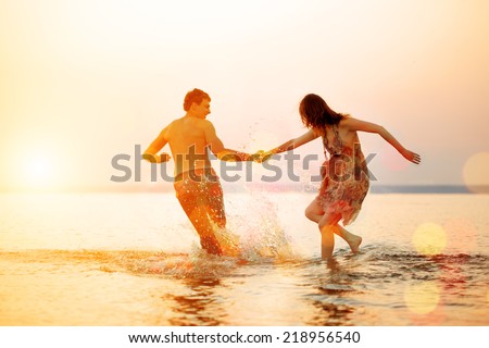 Summer beach party fun holiday on beach background. Couple in love in beach party. Summer scene about sunset sky.