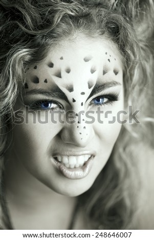 Beauty woman with makeup in snow leopard style. Fashion makeup model face. Luxury girl with trendy make up