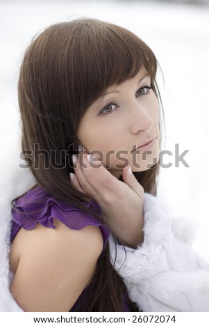 Picture of a girl who lies on the snow in the purple dress