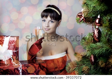 Images of the beautiful Santa girl sitting under the tree
