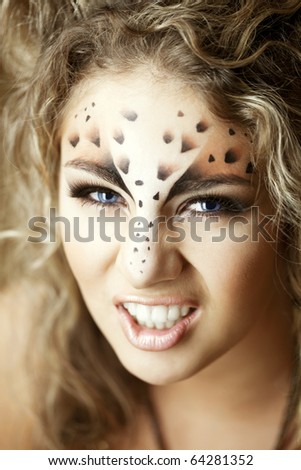 Beauty woman with makeup in snow leopard style. Fashion makeup model face. Luxury girl with trendy make up