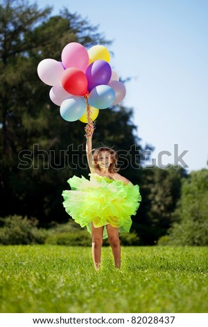 The image of a child with a bunch of balloons in their hands