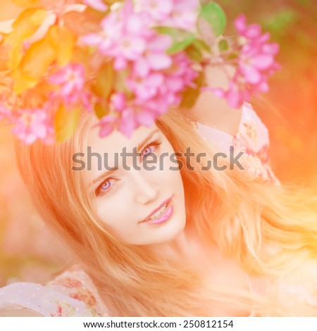 Young spring fashion woman  in spring garden. Springtime. Trendy girl at sunset in spring landscape background. Allergic to pollen of flowers. Spring allergy
