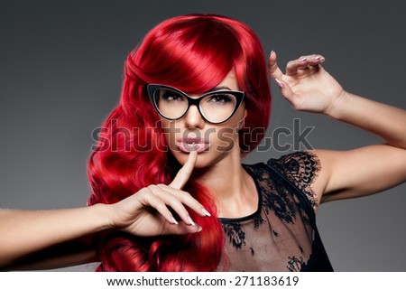 Luxury fashion trendy  young  woman with red curled hair in glasses. Optics. Girl with beauty hairstyle. Model with long stylish  bangs, wave, curly hair. Lady with a beauty face. Secret, gossip, news