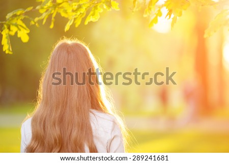 Young woman with long hair turned back  outdoors in sun light Warm Color Tones Beauty Sunshine woman Backlit Sunny Summer Day Autumn Summertime Glow Sun