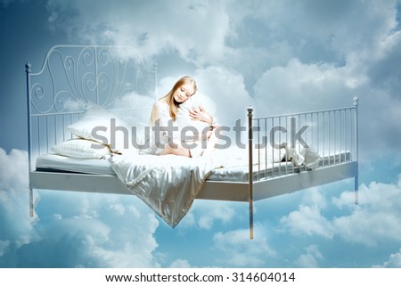 Sleeping woman. Girl with a pillow and blanket on the bed among the clouds in dreams
