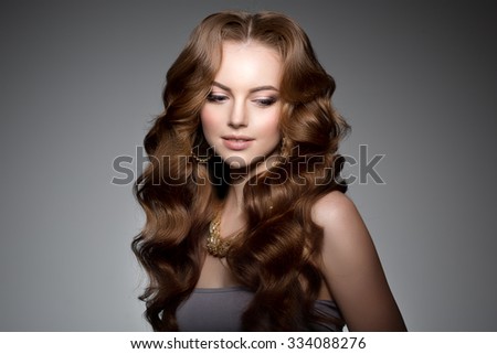 Model with long hair. Waves Curls Hairstyle. Hair Salon. Updo. Fashion model with shiny hair. Woman with healthy hair girl with luxurious haircut. Hair loss Girl with hair volume.