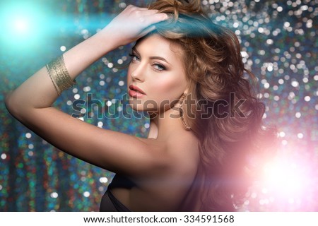 Woman club lights party background Dancing girl Long hair. Waves Curls Updo Hairstyle. Hair Salon Fashion model with shiny healthy hair with luxurious haircut. Hair volume Jewelry Bracelets Earrings