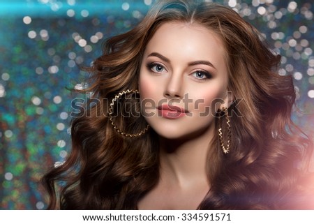 Woman club lights party background Dancing girl Long hair. Waves Curls Updo Hairstyle. Hair Salon Fashion model with shiny healthy hair with luxurious haircut. Hair volume Jewelry Bracelets Earrings