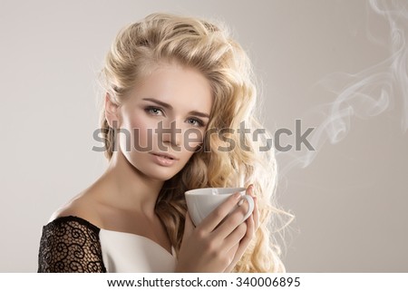 Model with coffee cup, mug in coffee shop. Fashion Woman, tea party time. Green Black. Blonde girl, tea set