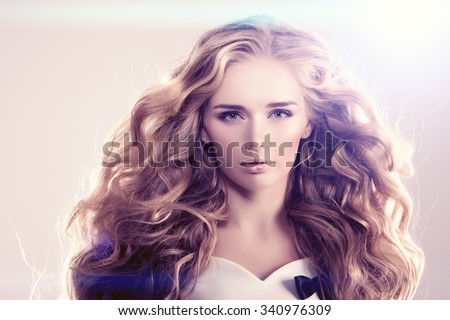 Model with long hair Blonde Waves Curls Hairstyle Hair Salon Updo Fashion model with shiny hair Woman with healthy hair girl with luxurious haircut Hair loss Girl with hair volume lights