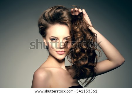 Model with long hair. Waves Curls Hairstyle. Hair Salon. Updo. Fashion model with shiny hair. Woman with healthy hair girl with luxurious haircut. Hair loss Woman with hair volume.