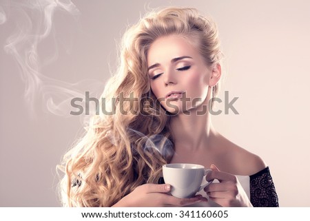 Model with coffee cup, mug in coffee shop. Fashion Woman, tea party time.  Blonde girl, tea set