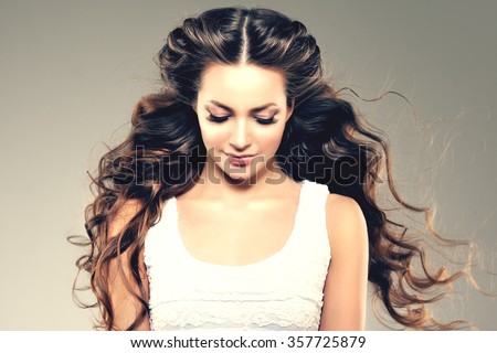 Model with long hair. Waves Curls Hairstyle. Hair Salon. Updo. Fashion model with shiny hair. Woman with healthy hair girl with luxurious haircut. Hair loss Girl with hair volume.