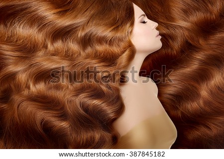 Model with long red hair. Waves Curls Hairstyle. Hair Salon. Updo. Fashion model with shiny hair. Woman with healthy hair girl with luxurious haircut. Hair loss Girl with hair volume.