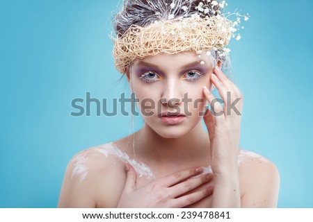 Winter beauty young woman portrait,model creative image with frozen makeup, with porcelain skin and long white lashes showing trendy, Ice-queen, Snow Queen, Easter