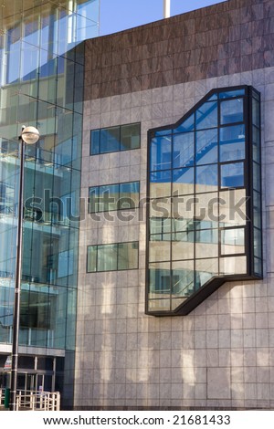 Detail from a modern building faced in glass and polished marble