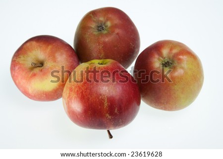 Four ripe apples isolated on a plain background