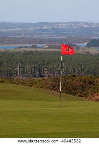 Putting green and flag on an English links golf course