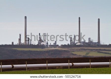 Oil refinery in the Welsh countryside with new pipe line in  foreground