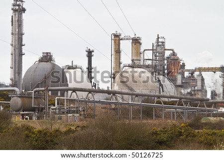 Oil refinery in the Welsh countryside with moderate heat haze generated by the industrial process