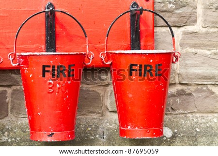Two slightly battered hanging fire buckets