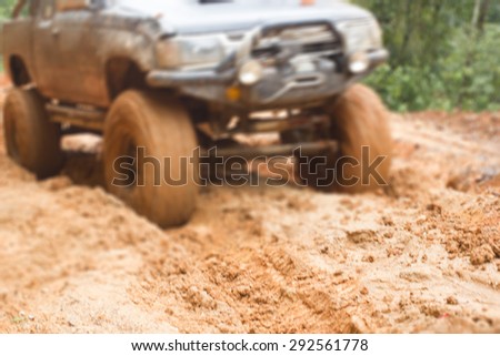 blurred car tires in dirt road