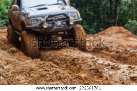 blurred car tires in dirt road