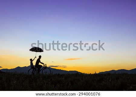 Biker family silhouette , family on the nature at sunset.
